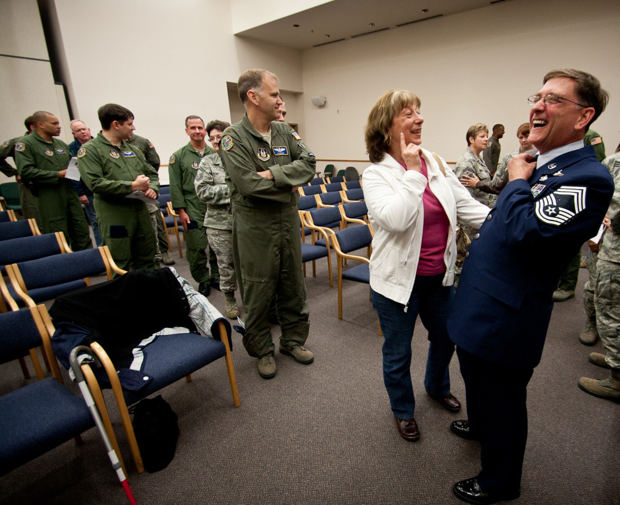 Chief Master Sgt. Richard Lutz, a C-17 Globemaster III Loadmaster Instructor and Evaluator, with the 728th Airlift Squadron, chuckles with his wife Michelle at his promotion ceremony to the highest and most honorable enlisted rank Oct. 1. Lutz has more than 6,900 flying hours. He lives in Graham with his wife and two sons.  (U.S. Air Force photo by Staff Jon Polka)