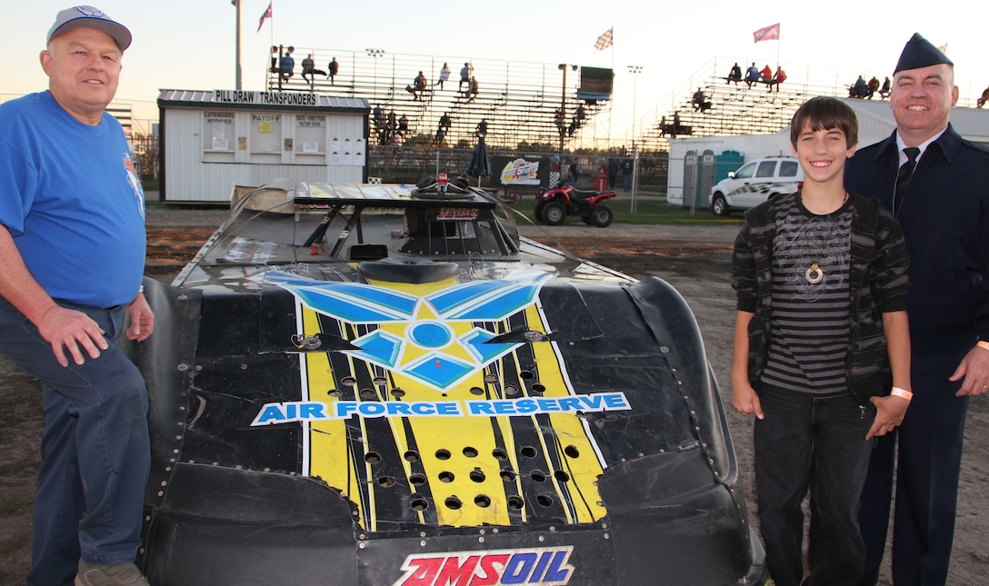 Retired Senior Master Sgt. Bob Salter stands next to his race car that displays the Air Force Reserve logo at Tri-City Speedway in Granite City, Ill.  Joining Salter is Senior Master Sgt. Jerry Hancock, 932nd Airlift Wing senior recruiter and his son, Will.  Salter and his son, Rick, have been racing locally for years.  Since Salter retired from the 932nd AW he and his race car team have supported wing recruiters at many racing events throughout souther Illinois.  (U.S. Air Force photo/Tech. Sgt. Dan Oliver)