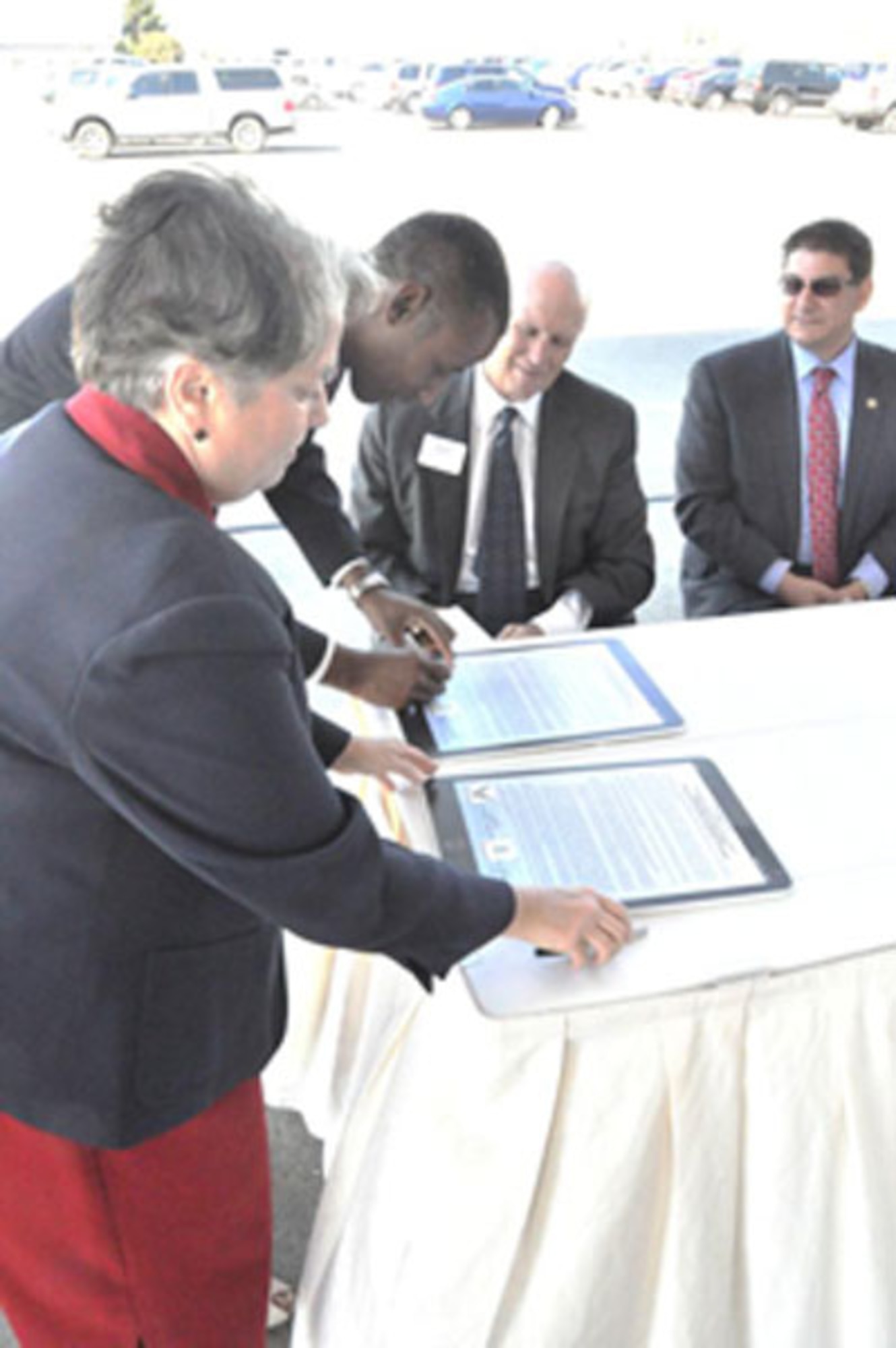 Jane Diamond, US EPA, Region 9, Superfund Director and Timothy Bridges, Deputy Assistant Secretary of the Air Force for Environment, Safety and Occupational Health, sign a Memorandum of Understanding to partner by sharing data and strategies on conducting the greenest cleanups with the smallest environmental footprint possible. Looking on are Larry Kelley, President, McClellan Business Park and Supervisor Phil Serna, Sacramento County District 1. (Photo by Scott Johnston, AFRPA)