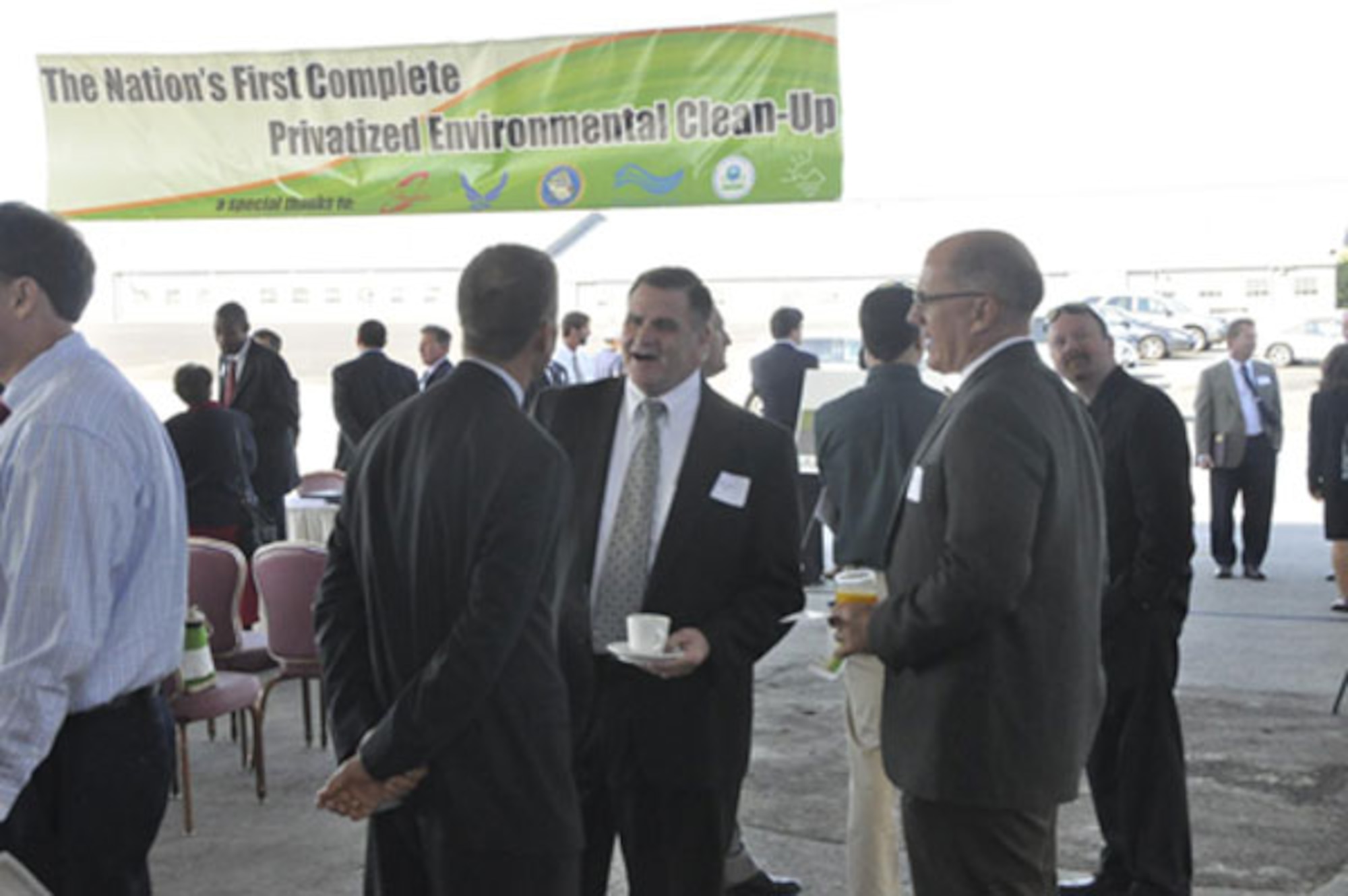 Director, Bob Moore and Greg Gangnuss, Air Force Real Property Agency, talk with Clark Whitten from Sacramento County at McClellan’s privatized cleanup event.