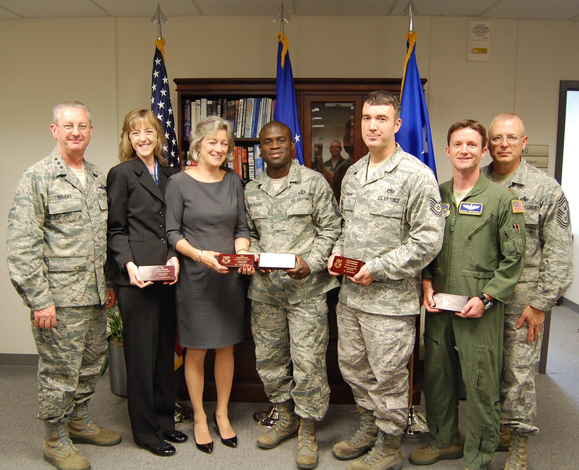 SCOTT AFB, Ill. - Lt. Gen. Mark Ramsay, Commander, 18th Air Force (left) and Chief Master Sgt. Jeffrey Williams, 18th Air Force Command Chief (far right), presented the command's hadquarters-level third quarter awards here October 4. From left to right, Renee Monday, Civilian of the Quarter, Category II; Barbara Jacob, Civilian of the Quarter, Category III; Senior NCO of the Quarter, Master Sgt. Larry Jackson; NCO of the Quarter, Tech. Sgt. Daniel O'Brennan; and Field Grade Officer of the Quarter, Maj. Brian Tavernier  (U.S. Air Force Photo/Maj. Michael Meridith). 