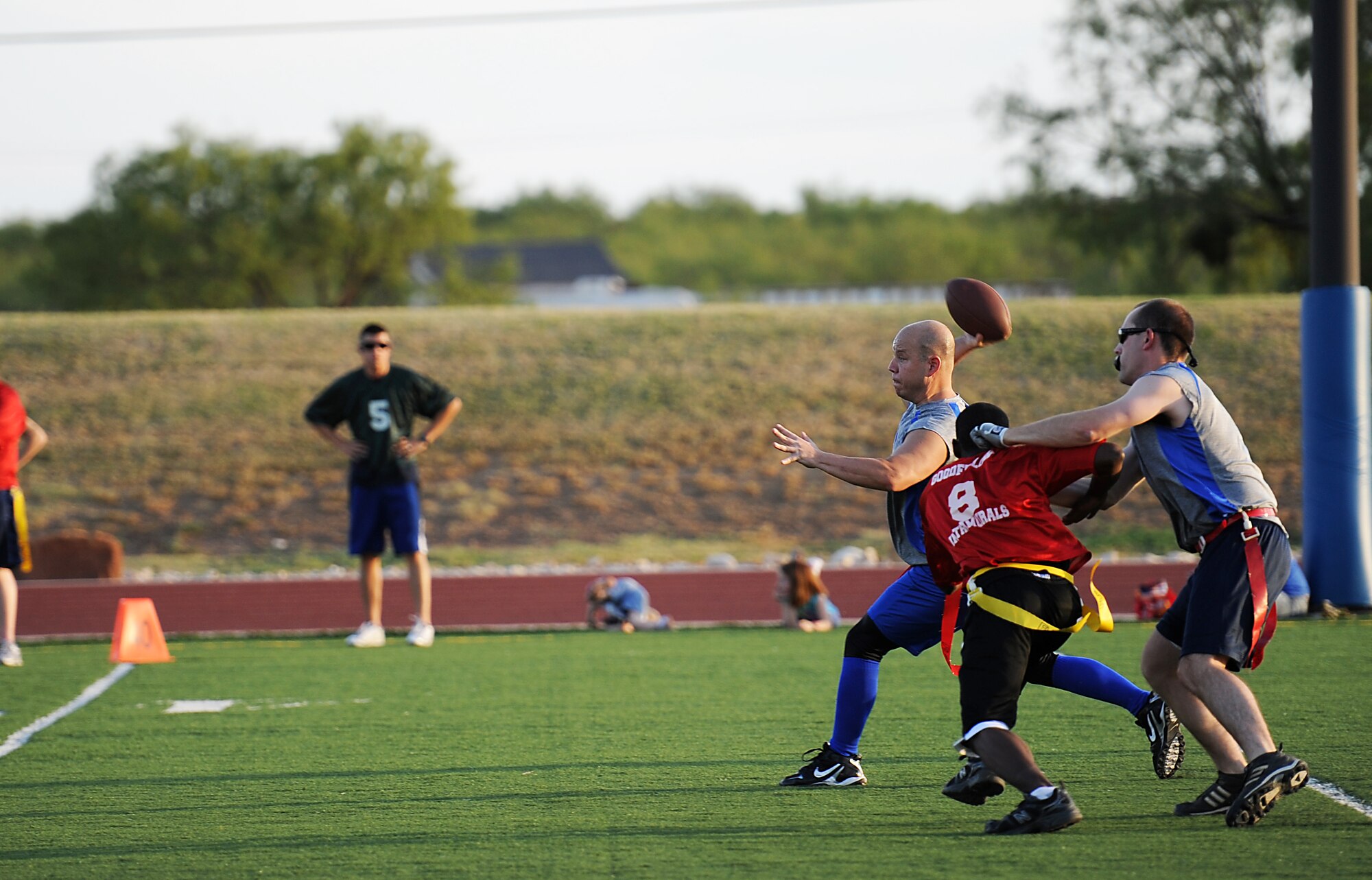 GOODFELLOW AIR FORCE BASE, Texas -- The 316th Training Squadron Sharks quarterback pulls back for the throw before getting sacked by a 1st Responders lineman Sept. 29. The Sharks beat the 1st Responders, 18-7, them into the loser’s bracket of the flag football tournament. (U.S. Air Force photo/Airman 1st Class Michael Smith)