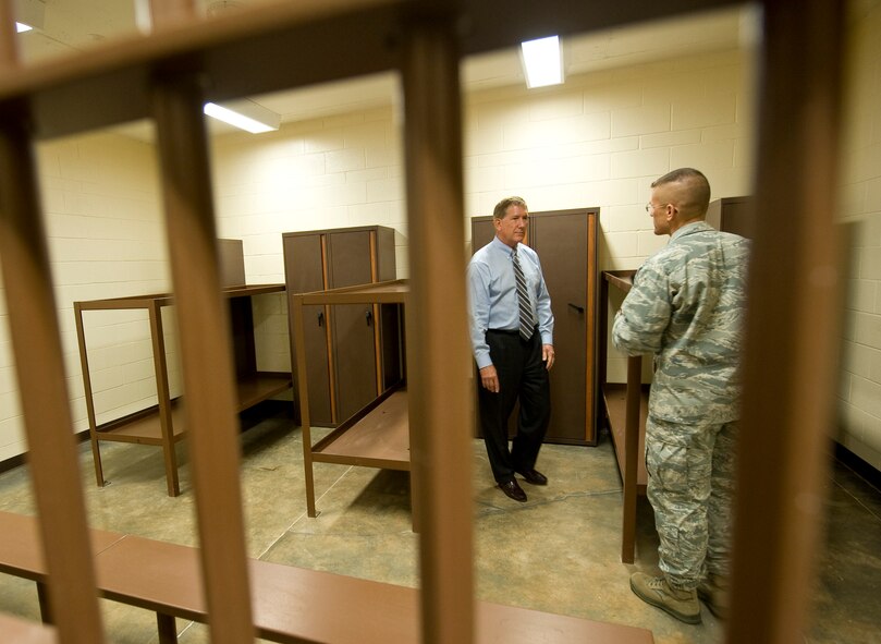 Lt. Col. Jonpaul Mickle, 2nd Security Forces Squadron commander, gives a tour of the new confinement facility to Hon. Terry Yonkers, Assistant Secretary of the Air Force for Installations, Environment and Logistics, during his visit to Barksdale Air Force Base, La., Oct. 4. The facility is part of the newly opened Security Forces compound here. (U.S. Air Force photo/Senior Airman Chad Warren)(RELEASED)