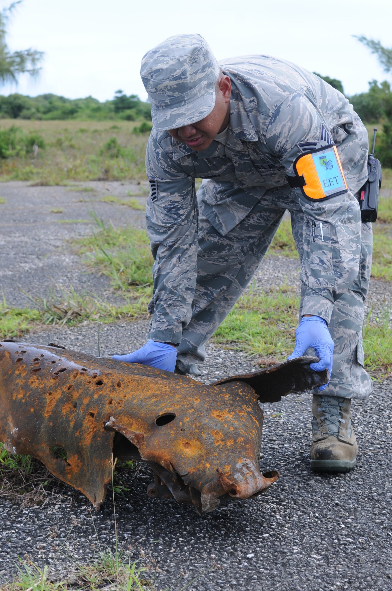 ANDERSEN AIR FORCE BASE, Guam – Tech. Sgt. Wyll Yabut, 36th Medical Operations Squadron Exercise Evaluation Team member, places a piece of scrap metal down as part of a major accident response exercise, Oct. 3. The exercise is designed to test the response capabilities of all medical and security personnel.(U.S. Air Force photo/ Senior Airman Carlin Leslie)