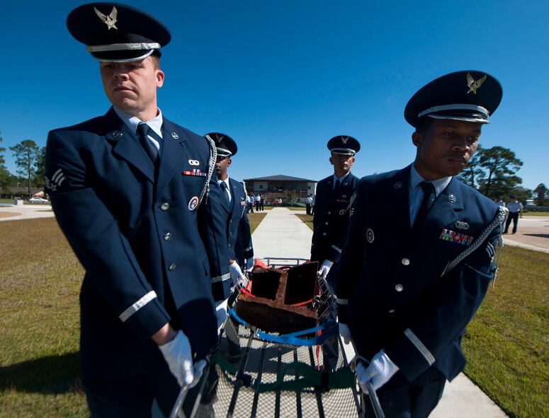 Moody Air Force Base Honor Guard members carry a litter holding a piece of steel from the World Trade Center buildings at Moody AFB, Ga., Oct. 3, 2011. The 111-pound of steel will be displayed at the 23rd Wing's headquarters building until it is relocated to Moody's heritage center. (U.S. Air Force photo by Airman 1st Class Joshua Green/Released)      
