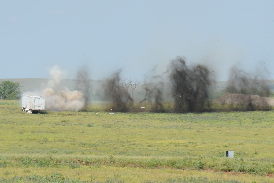 An A-10C Thunderbolt from Whiteman AFB demonstrates the destructive power of its 30 mm rotary cannon on a ground target at the 2011 Smoky Hill Open House.