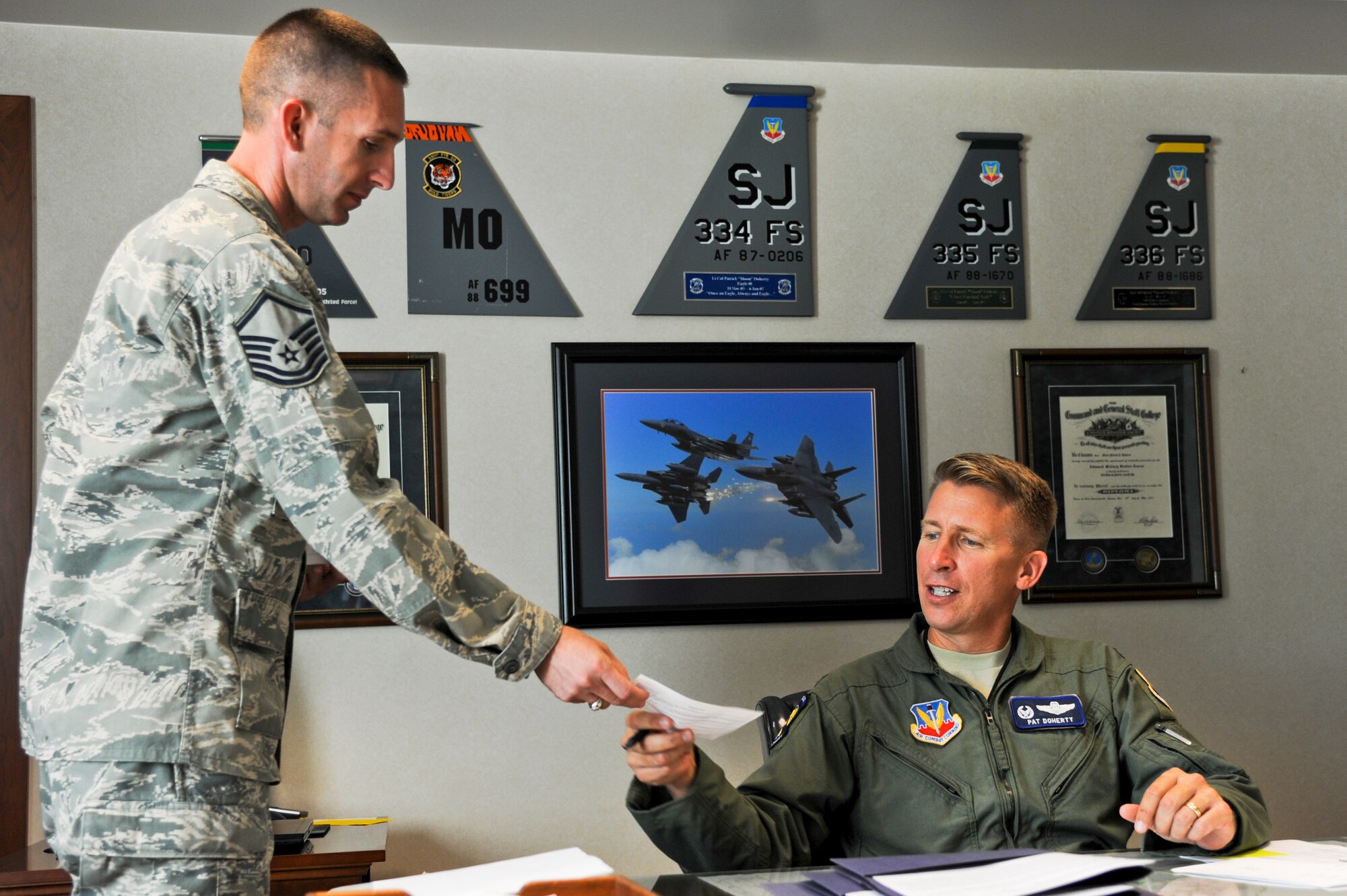 Master Sgt. Nelson Ortega, 4th Fighter Wing exercise planner evaluator, collects a Combined Federal Campaign (CFC) donation slip from Col. Patrick Doherty, 4th Fighter Wing commander, on Seymour Johnson Air Force Base, N.C., Sept. 30, 2011. Doherty’s contribution helped kick-off the 50th anniversary of the campaign with a base goal of $218,000. The CFC gives federal employees an opportunity to give back to our community by providing charitable contributions to those in need. (U.S. Air Force photo by Tech. Sgt. Colette M. Graham)