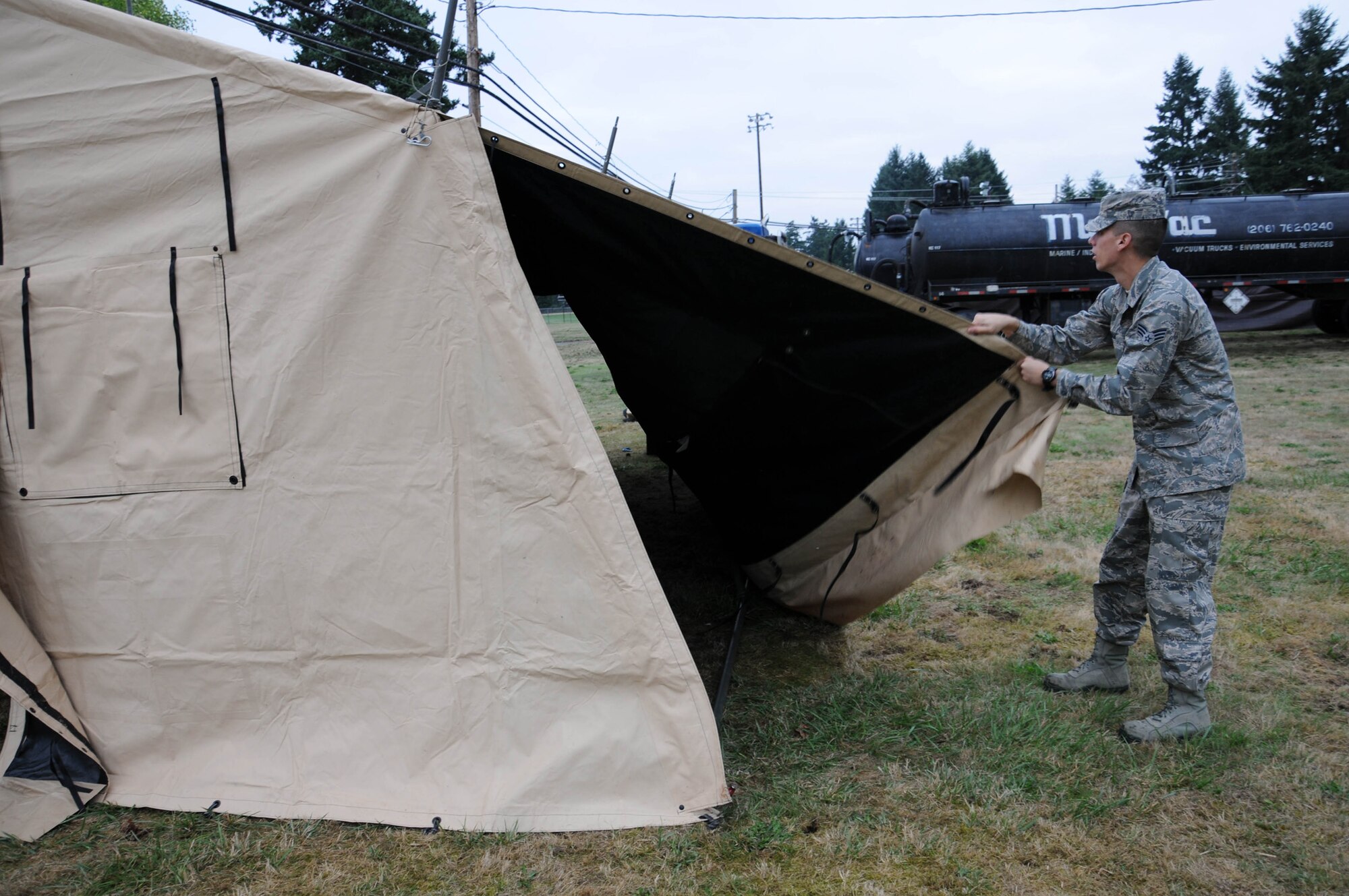 Air Force Senior Airman Allen Pham, a 446th Force Support Squadron Sustainment Services Flight apprentice, does his part to take down the single paletized expanded kitchen tent Oct. 2, 2011 at MCChord Field as part of an annual training requirement for the flight. Pham is a full-time nursing student at Spokane Falls Community College, Spokane, Wash. The Spokane resident and his wife are expecting a baby in Febuary 2012. (U.S. Air Force photo by 2nd Lt. Denise Hauser)
