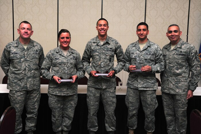 Colonel Richard McComb and Chief Master Sgt. Jose LugoSantiago recognize Airman 1st Class Angela Setliff, Senior Airman Matthew Baxter and Airman 1st Class Alexander Ortiz as Diamond Sharp award winners during a ceremony at the Charleston Club Oct. 4.  Diamond Sharp awardees are Airman chosen by their first sergeants for their excellent performance. McComb is the Joint Base Charleston commander, LugoSantiago is the 628th Air Base Wing command chief, Setliff is from the 1st Combat Camera Squadron, Baxter is from the 628th Security Forces Squadron and Ortiz is from the 628th Medical Group.  (U.S. Air Force photo/ Staff Sgt. Nicole Mickle)  
