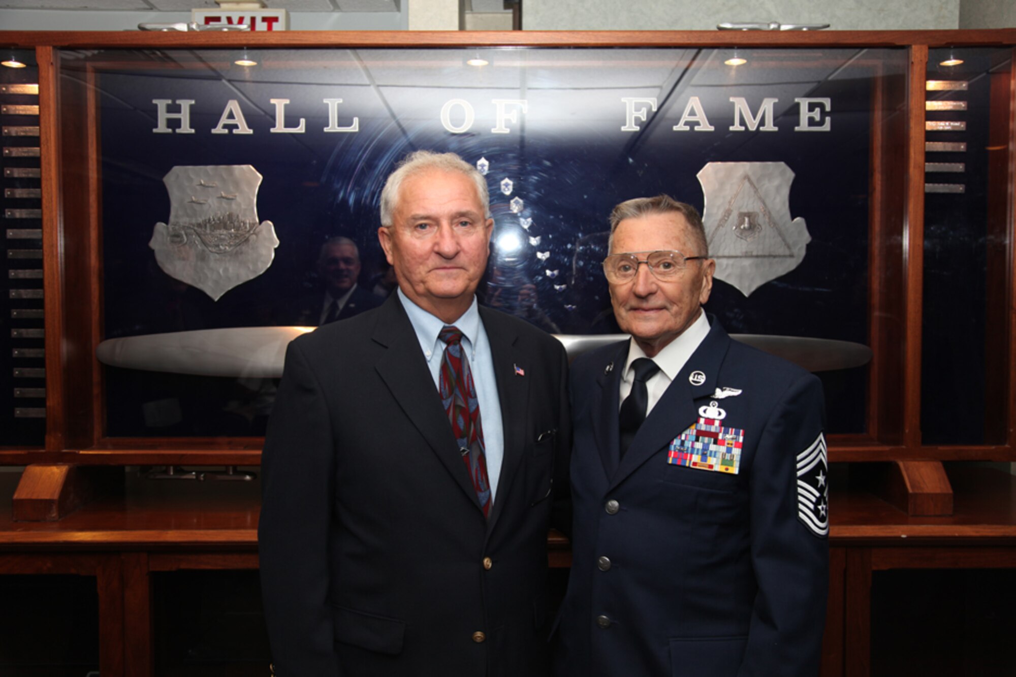 Senior Master Sgt. (retired) Charles E. Mathias stands with Chief Master Sgt. (retired) John G. Farhny, Jr., the creator of the 911th Hall of Fame Award in the background, Oct. 1. Chief Master Sgt. Fahrny created and designed the award in 1989 to recognize anyone who has been a strong supporter of the enlisted cause. (U.S. Air Force photo/Senior Airman Jonathan Hehnly)
