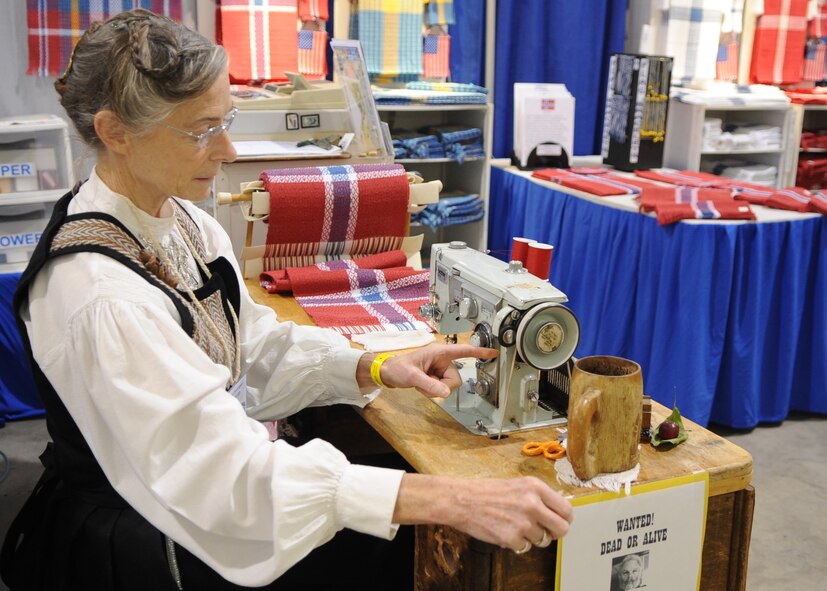 MINOT, N.D. – Julie Karsky, Norsk Hostfest exhibitor, threads a sewing machine here, Sept 30. The Norsk Hostfest displayed dozens of Scandinavian influenced arts and crafts. Visitors were not only able to buy these items, but also had the opportunity to see how they were made. The Minot Norsk Hostfest is North America’s largest Scandinavian festival and successfully integrates Minot Airmen and residents together. The festival started Sept. 27 and ended Oct. 1 at the Minot State Fair Grounds. (U.S. Air force photo/Senior Airman Ashley N. Avecilla)