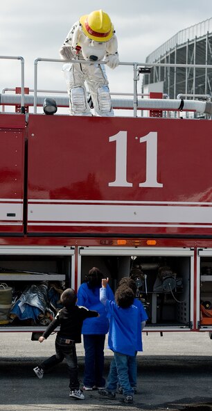 Sparky, a mascot with the 436th Civil Engineer Squadron talks to kids at the FanZone Oct. 1, 2011, prior to the OneMain Financial 200 NASCAR Nationwide Series race at Dover International Speedway in Dover, Del. (U.S. Air Force photo by Roland Balik)