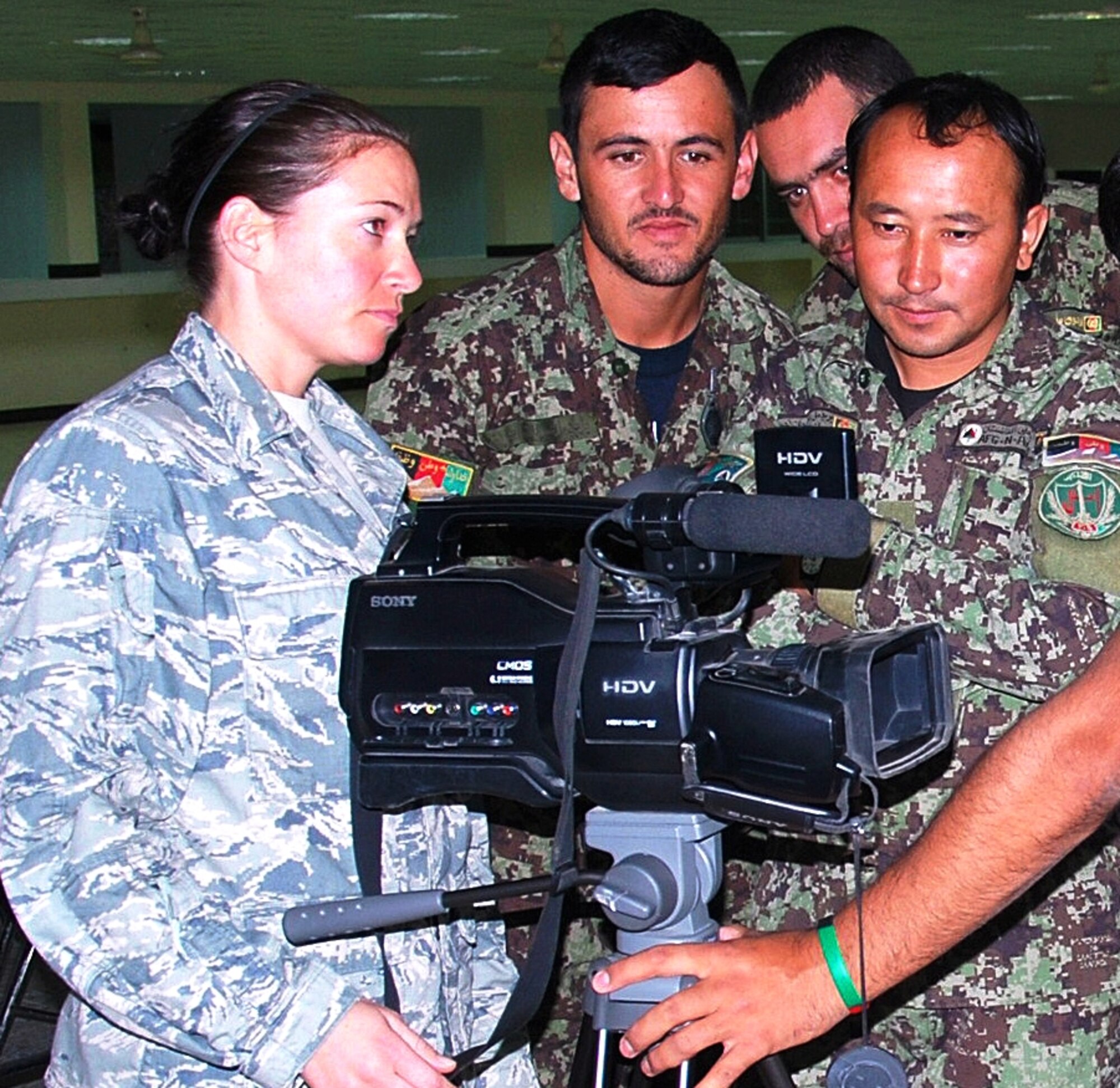 Air Force Staff Sgt. Katerina Slivinske explains the features of a video camera to public affairs officers of the Afghan National Army's 205th Corps during a public affairs seminar at Camp Hero Sept. 18 in Kandahar. (Photo by ANA 205th Corps Public Affairs)