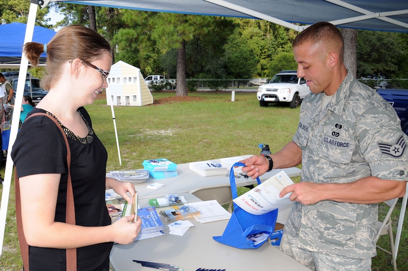 Staff Sgt. Nicholas Altgilbers, Joint Base Charleston Emergency Management team member, teaches Navy spouse Katie Ayala about the basic necessities to consider when preparing for a natural disaster during the Emergency Preparedness Fair at JB Charleston - Weapons Station, Sept. 29. The fair provided advice and information on  preparing an emergency supply kit, a family emergency plan and how to safely operate items such as generators and chainsaws. (U.S. Navy photo/Petty Officer 1st Class Class Brannon Deugan)
