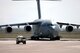 A C-17 Globemaster III cfrom the 62nd Airlift Wing, on deployment from McChord Air Force Base, Wash., follows a High-Mobility Multipurpose Wheeled Vehicle (HMMWV) transient alert vehicle to a parking spot during airfield operations at Karshi-Khanabad Air Base, Uzbekistan, on March 20, 2005, during Operation Enduring Freedom operations.  (U.S. Air Force Photo/Master Sgt. Scott T. Sturkol) 