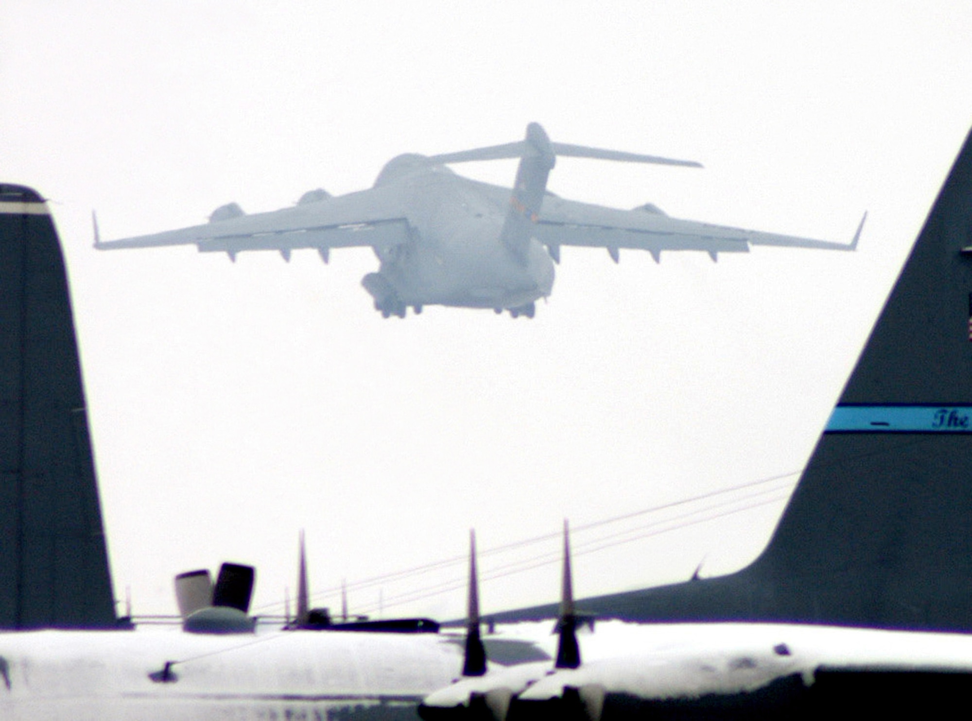 A C-17 Globemaster III cargo aircraft takes off at Karshi-Khanabad Air Base, Uzbekistan, on Feb. 12, 2005, during Operation Enduring Freedom operations there. (U.S. Air Force Photo/Master Sgt. Scott T. Sturkol)