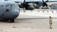 Crew chief Tech. Sgt. Robert Rothove, signals a C-130 Hercules cargo aircraft to come to a stop at Karshi-Khanabad Air Base, Uzbekistan, on Jan. 17, 2005, in support of Operation Enduring Freedom. (U.S. Air Force Photo/Master Sgt. Scott T. Sturkol)