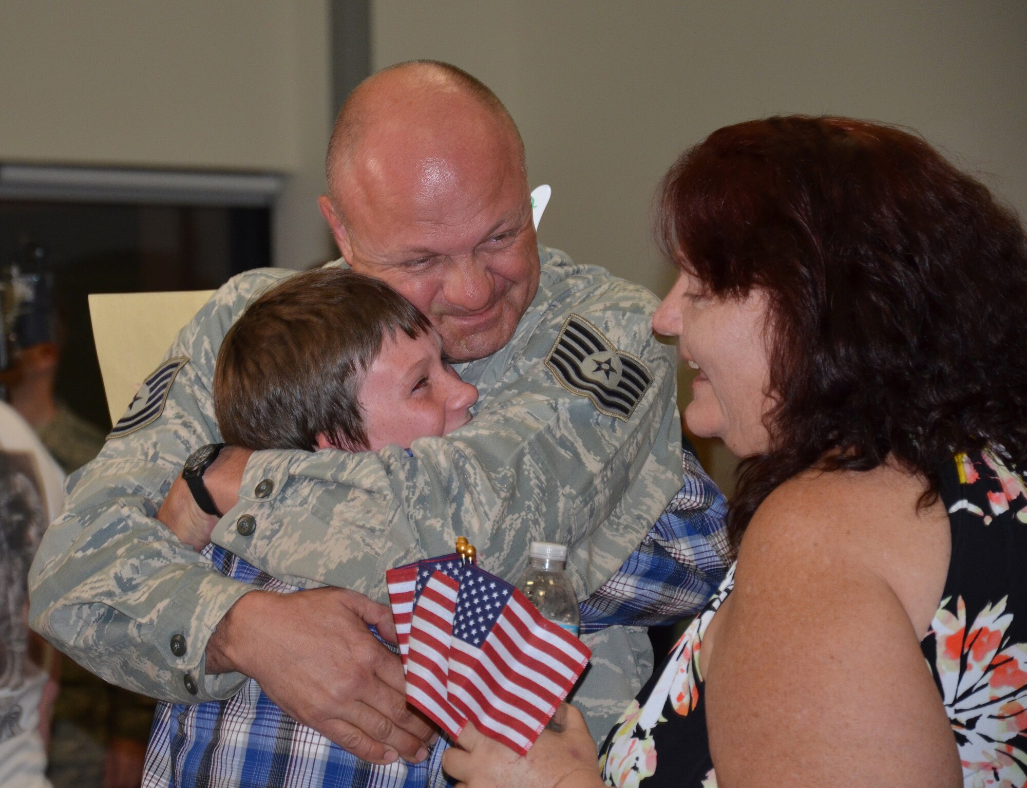 PATRICK AIR FORCE BASE, Fla. - Tech. Sgt. Patrick Gardner, Air Force reservist from the 920th Rescue Wing, hugs his family upon his return home after a 4-month deployment in support of  Operation Enduring Freedom, Oct. 3, 2011. During this rotation, the reservists are credited with flying 505 rescue missions; successfully saving 358 lives; and assisting in saving another 287 lives. (U.S. Air Force photo/Capt. Cathleen Snow)