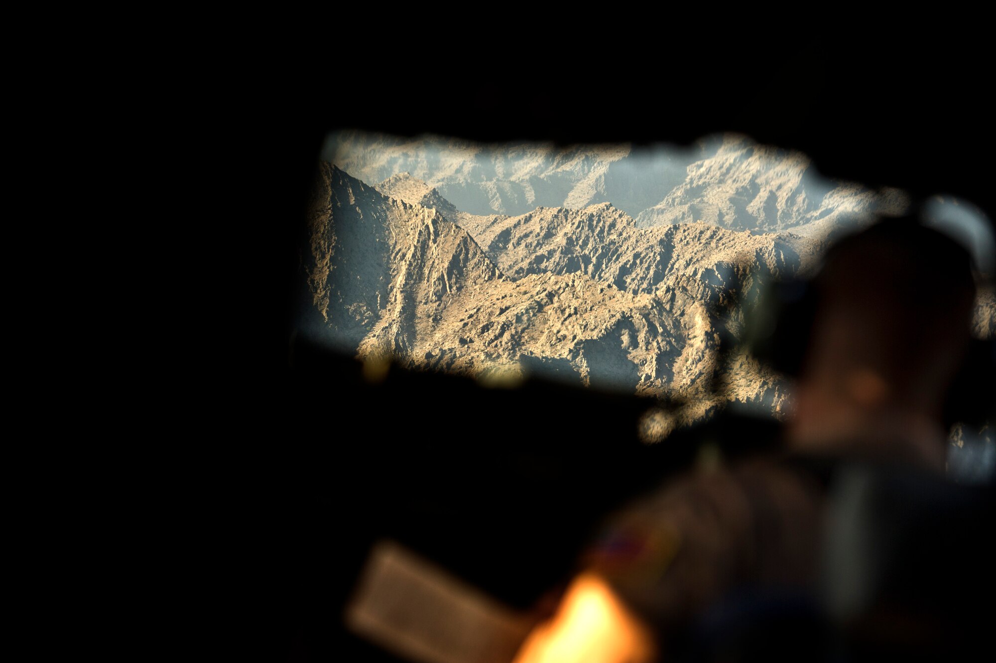 U.S. Air Force 1st Lt. Christopher Oerter, a C-17 Globemaster III pilot assigned to the 816th Expeditionary Airlift Squadron, flies a low level approach to a drop zone in Afghanistan on Sept 30, 2011. Oerter and the crew navigated the C-17 through the mountainous terrain before delivering 40 bundles of supplies to a remote outpost in Afghanistan. Aerial delivery of critical supplies decreases the total number of resupply convoys conducted in high threat areas.  (U.S. Air Force Photo/Master Sgt. Jeffrey Allen)