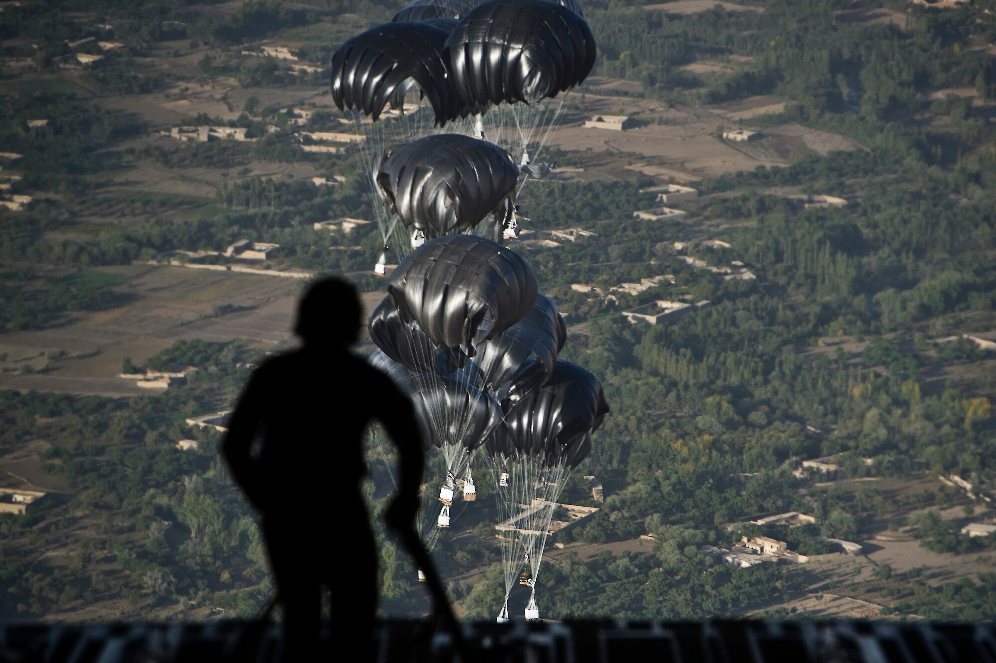 U.S. Air Force Staff Sgt. Peter Jensen, a loadmaster assigned to the 816th Expeditionary Airlift Squadron, collects straps that restrained airdrop bundles in the back of a C-17 Globemaster III on Sept 30, 2011. Jensen and the crew of the C-17 air dropped 40 bundles to a remote outpost in Afghanistan. Aerial delivery of critical supplies decreases the total number of resupply convoys conducted in high threat areas.  (U.S. Air Force Photo/Master Sgt. Jeffrey Allen)