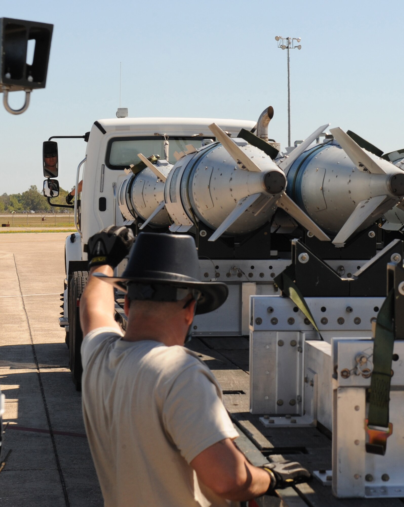 An Airman from the 2nd Munitions Squadron signals a driver to stop during the Global Strike Challenge Munitions Maintenance Competition on Barksdale Air Force Base, La., Oct. 3. Global Strike Challenge is the world's premier bomber, Intercontinental Ballistic Missile and security forces competition with units from Air Force Global Strike Command, Air Combat Command, Air Force Reserve Command and the Air National Guard. (U.S. Air Force photo/Airman 1st Class Micaiah Anthony)(RELEASED)