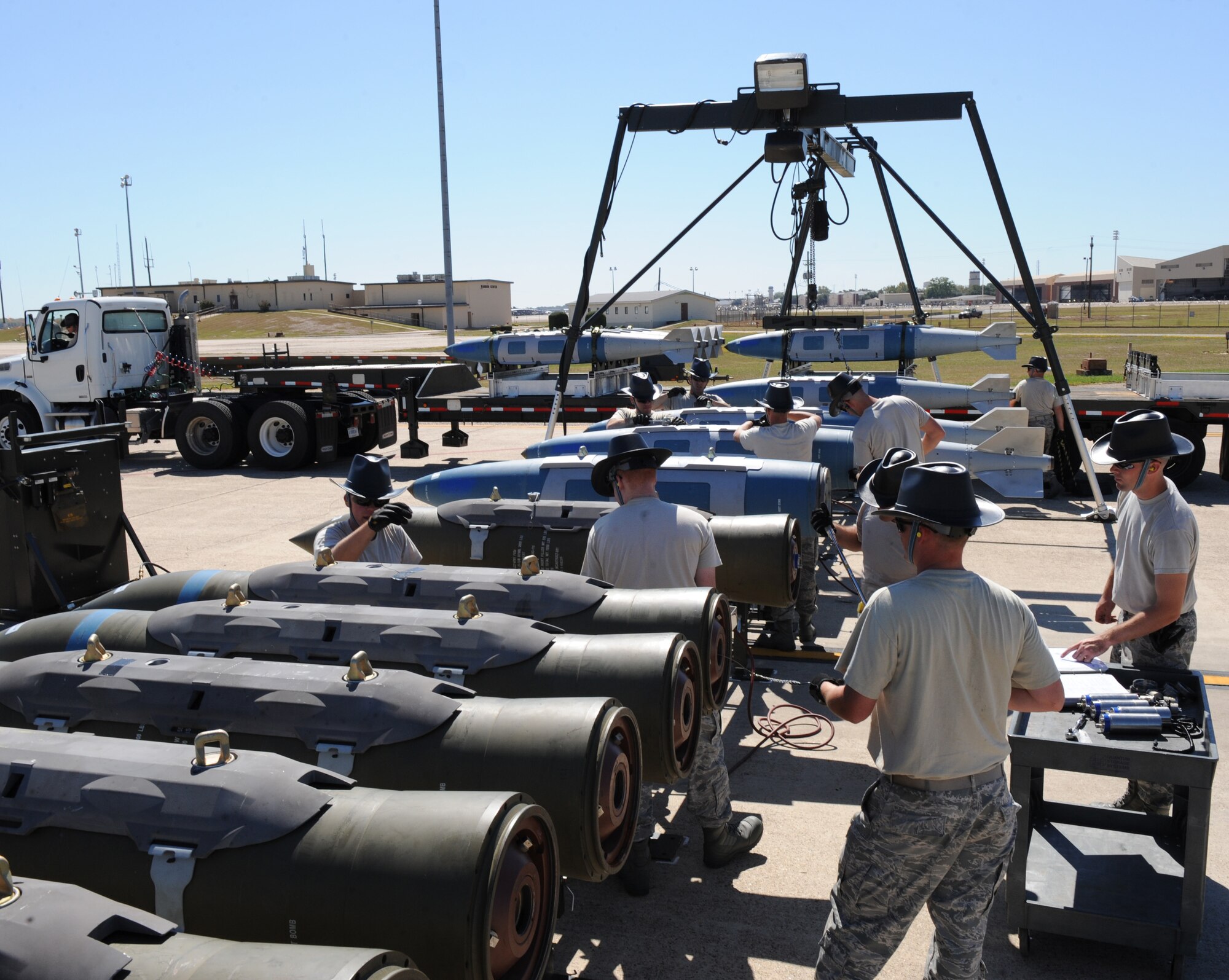 Airmen from the 2nd Munitions Squadron assemble inert 2000-pound bombs on a munitions assembly conveyer during the Global Strike Challenge Munitions Maintenance Competition on Barksdale Air Force Base, La., Oct. 3. Eleven Airmen from the 2 MUNS were selected to compete in the timed competition. (U.S. Air Force photo/Airman 1st Class Micaiah Anthony)(RELEASED)