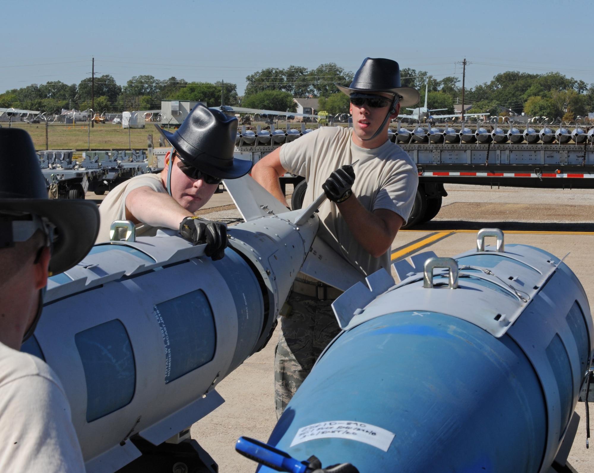 Airmen from the 2nd Munitions Squadron attach the tail section of a 2000-pound bomb during the Global Strike Challenge Munitions Maintenance Competition on Barksdale Air Force Base, La., Oct. 3. Eleven Airmen from the 2 MUNS were selected to compete in the timed competition. (U.S. Air Force photo/Airman 1st Class Micaiah Anthony)(RELEASED)