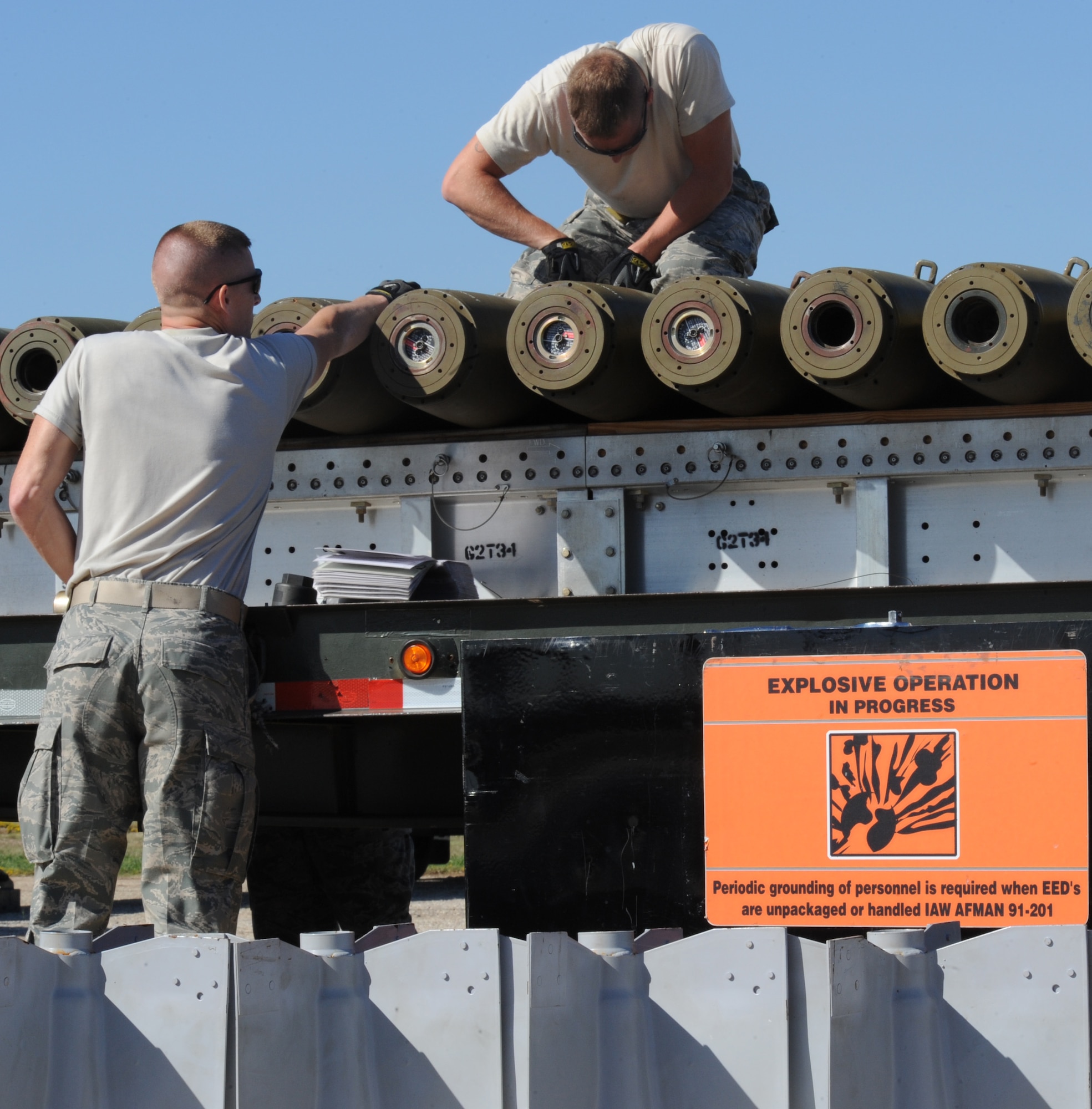 Airmen from the 2nd Munitions Squadron assemble bombs during the Global Strike Challenge Munitions Maintenance Competition on Barksdale Air Force Base, La., Oct. 3. The Airmen were timed to see how fast and accurately they could assemble and load 42 inert bombs onto trailers. (U.S. Air Force photo/Airman 1st Class Micaiah Anthony)(RELEASED)