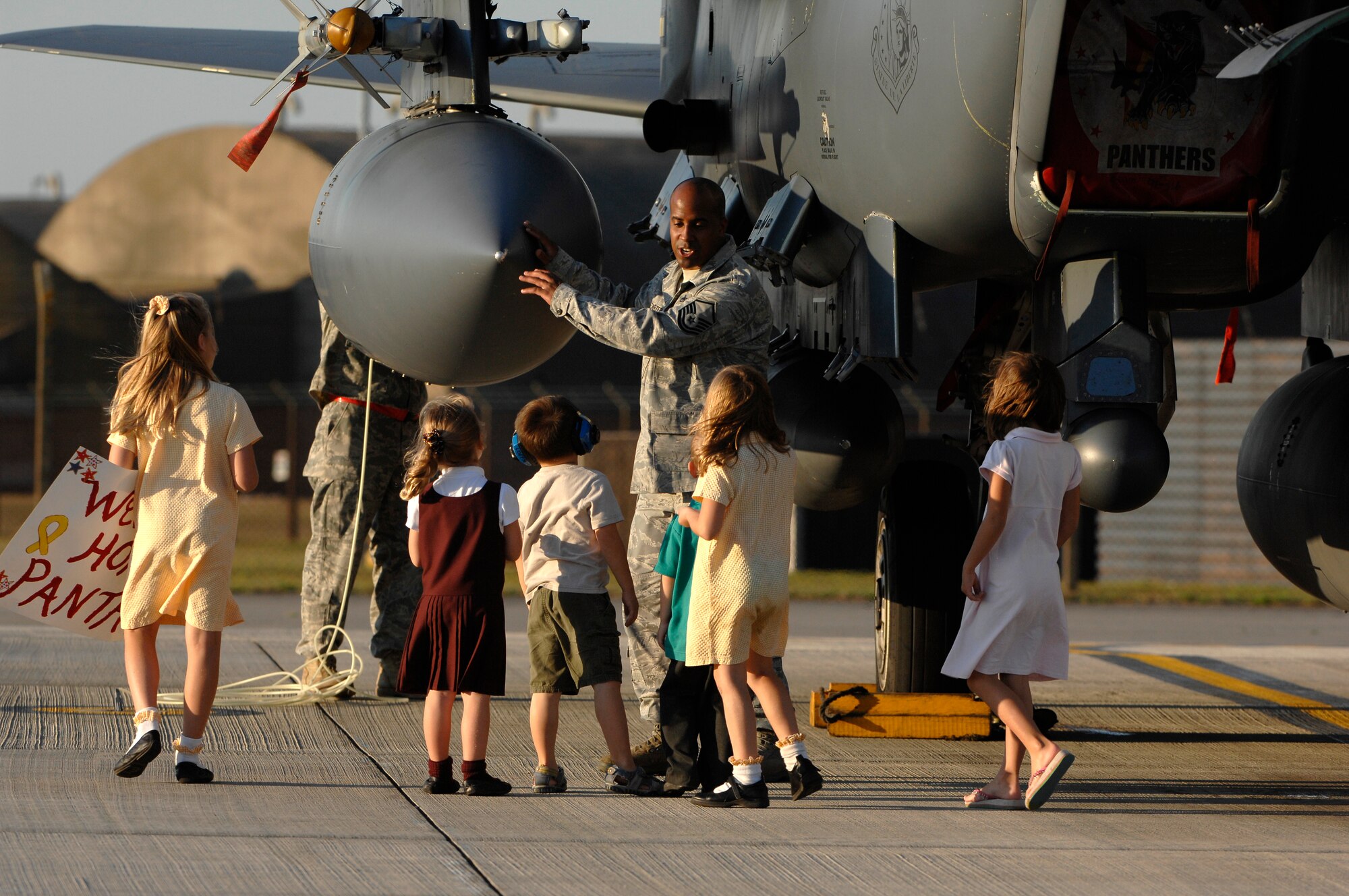 ROYAL AIR FORCE LAKENHEATH, England - Master Sgt. Kevin Carter, 494th Aircraft Maintenance Unit flight chief, explains the capabilities of an F-15E Strike Eagle to youth after the jets returned from deployment Sept. 30, 2011.  Members of the 48th Fighter Wing and families greeted Airmen of the 494th Fighter Squadron who returned from deployment to Kunsan Air Base, South Korea where they supported the 8th FW's mission. (U.S.  photo by Tech. Sgt. Lee A. Osberry Jr.)