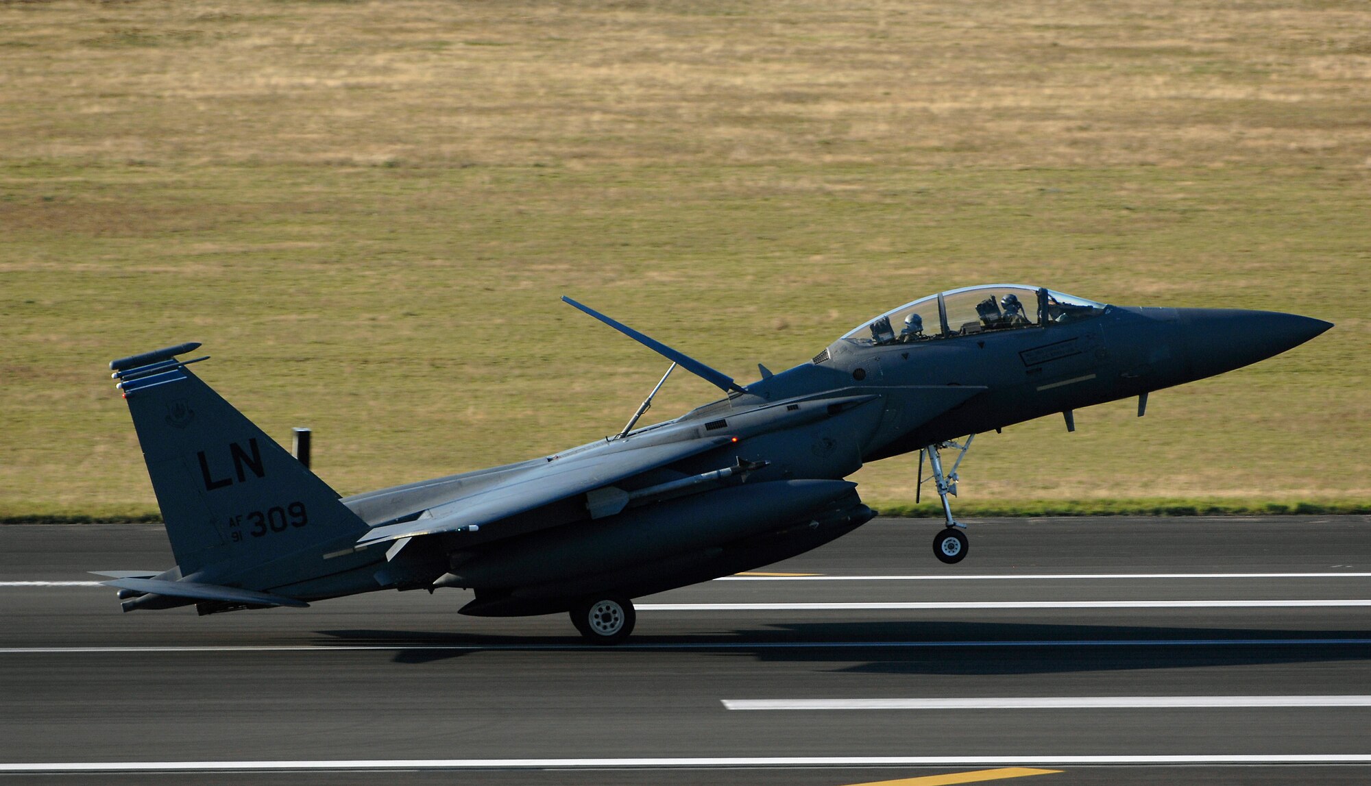 ROYAL AIR FORCE LAKENHEATH, England - An F-15E Strike Eagle lands here after a deployment Sept. 30, 2011.  Members of the 48th Fighter Wing and families greeted Airmen of the 494th Fighter Squadron who returned from deployment to Kunsan Air Base, South Korea where they supported the 8th FW's mission. (U.S.  photo by Tech. Sgt. Lee A. Osberry Jr.)