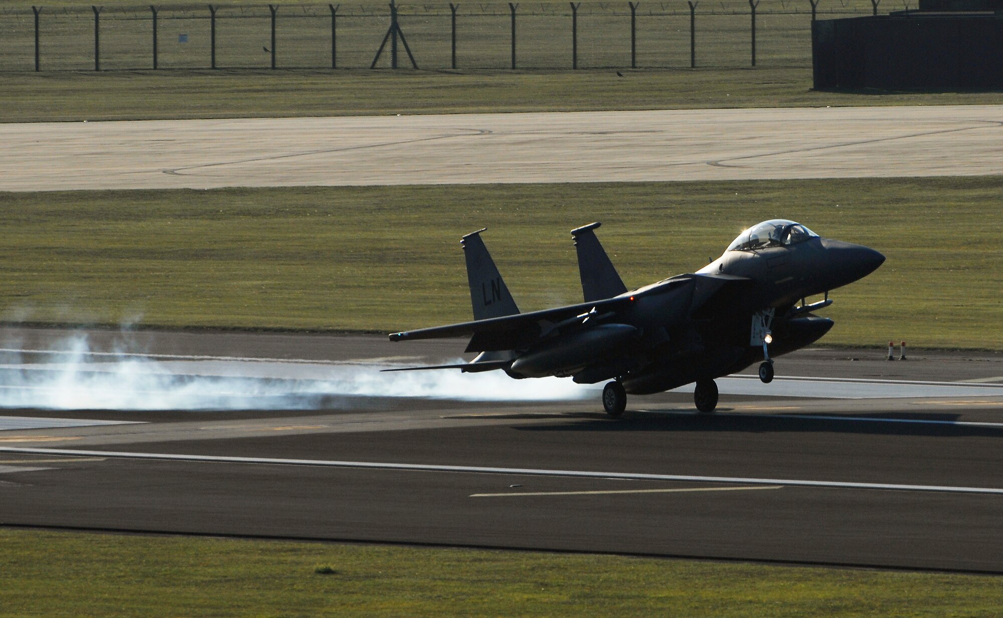 ROYAL AIR FORCE LAKENHEATH, England - The first F-15E Strike Eagle touches down here after a deployment Sept. 30, 2011.  Members of the 48th Fighter Wing and families greeted Airmen of the 494th Fighter Squadron who returned from deployment to Kunsan Air Base, South Korea where they supported the 8th FW's mission. (U.S.  photo by Tech. Sgt. Lee A. Osberry Jr.)