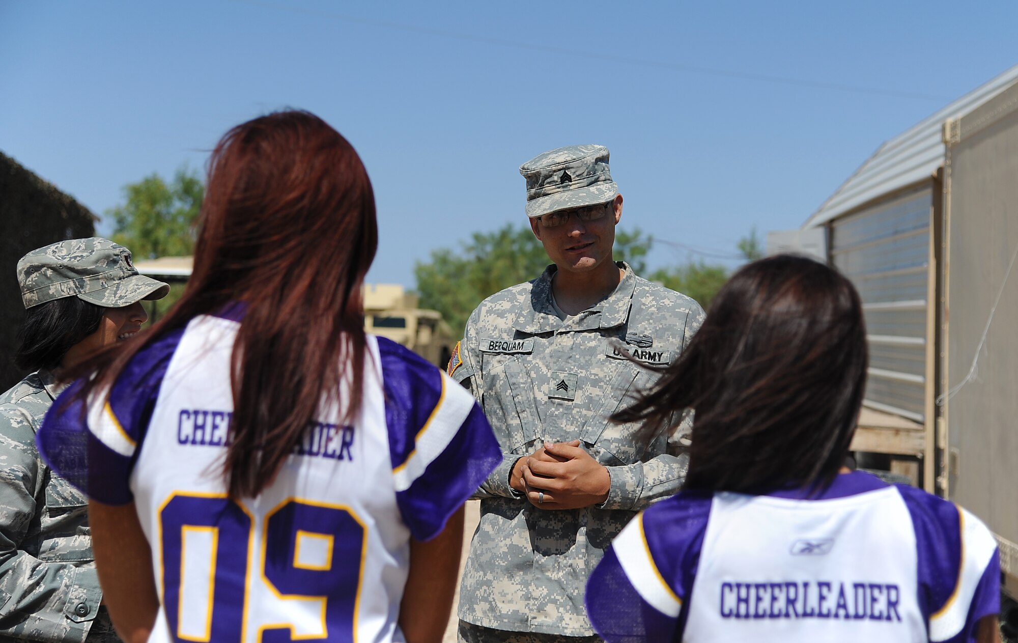 GOODFELLOW AIR FORCE BASE, Texas -- Army Staff Sgt. Thomas Berquam, 344th Military Intelligence Battalion Instructor, briefs two Minnesota Vikings cheerleaders about what takes place at Camp Sentinel Sept. 30. The two cheerleaders visited Goodfellow to boost morale. (U.S. Air Force photo/Airman 1st Class Michael Smith)   