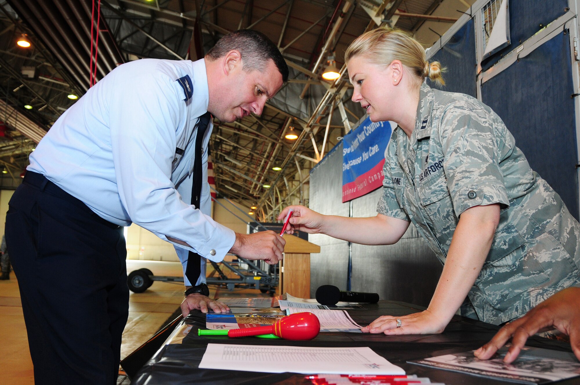 ROYAL AIR FORCE LAKENHEATH, England -- Col. William Lewis, 48th Fighter Wing vice commander, prepares to make a contribution to the Combined Federal Campaign at Hangar 7 on Oct. 3, 2011. This year is the 50th anniversary of the CFC, established in 1961 to support and promote charities through volunteers. (U.S. Air Force photo by Senior Airman Lausanne Morgan)