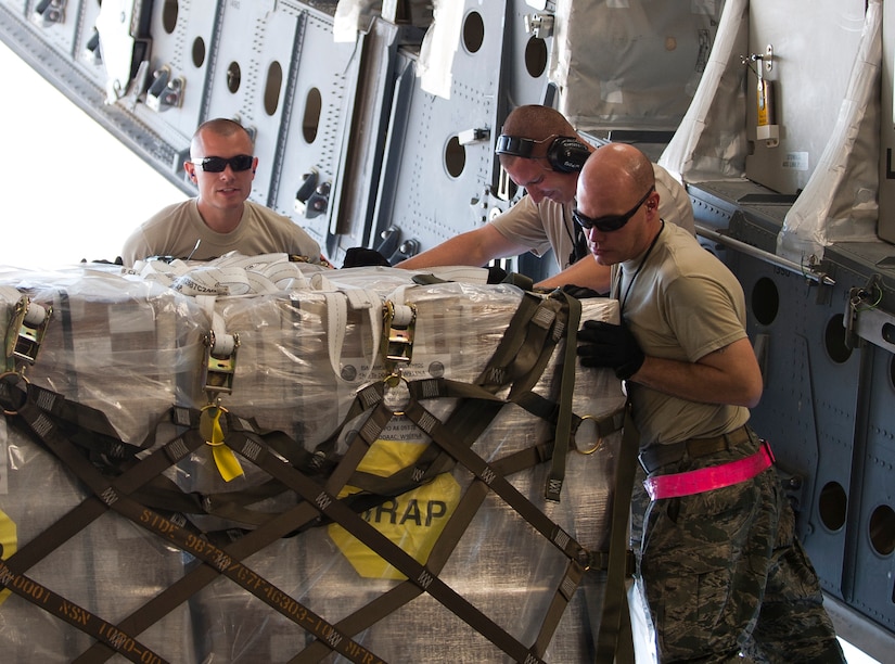 Staff Sgt. Nathan Dunn, right, works with other members of the 728th Air Mobility Squadron to move a pallet on a C-17 Globemaster III Oct. 3, 2011, at Incirlik Air Base, Turkey. Dunn is the first aerial port expeditor to reach 1,000 cargo loads. The APEX program allows cargo to be loaded onto aircraft without a loadmaster. (U.S. Air Force photo by Senior Airman Clayton Lenhardt/Released)