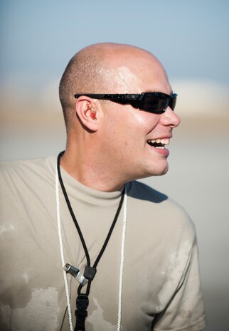 Staff Sgt. Nathan Dunn, 728th Air Mobility Squadron, celebrates his 1,000th load as an aerial port expeditor Oct. 3, 2011, at Incirlik Air Base, Turkey. Dunn is the first APEX Airman to reach this milestone. The APEX program allows cargo to be loaded onto aircraft without a loadmaster. (U.S. Air Force photo by Senior Airman Clayton Lenhardt/Released)
