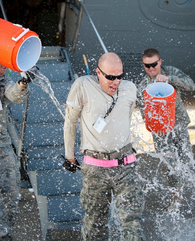 Staff Sgt. Nathan Dunn, 728th Air Mobility Squadron, is soaked with water to celebrate his 1,000th load as an aerial port expeditor Oct. 3, 2011, at Incirlik Air Base, Turkey. Dunn is the first APEX Airman to reach this milestone. The APEX program allows cargo to be loaded onto aircraft without a loadmaster. (U.S. Air Force photo by Senior Airman Clayton Lenhardt/Released)