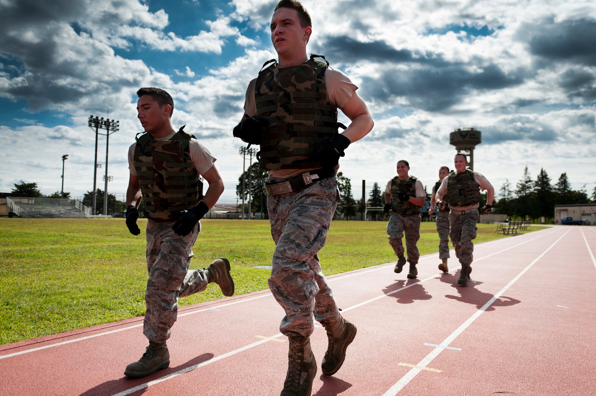 YOKOTA AIR BASE, Japan -- A team of Airmen from the 374th Maintenance Squadron accessories flight run a lap around the high school track during the Combat Endurance Challenge at Yokota Air Base, Japan, Oct. 1, 2011. The teams had to stay together and were not allowed to start a new task until each member had arrived at the station. (U.S. Air Force photo/Staff Sgt. Samuel Morse)