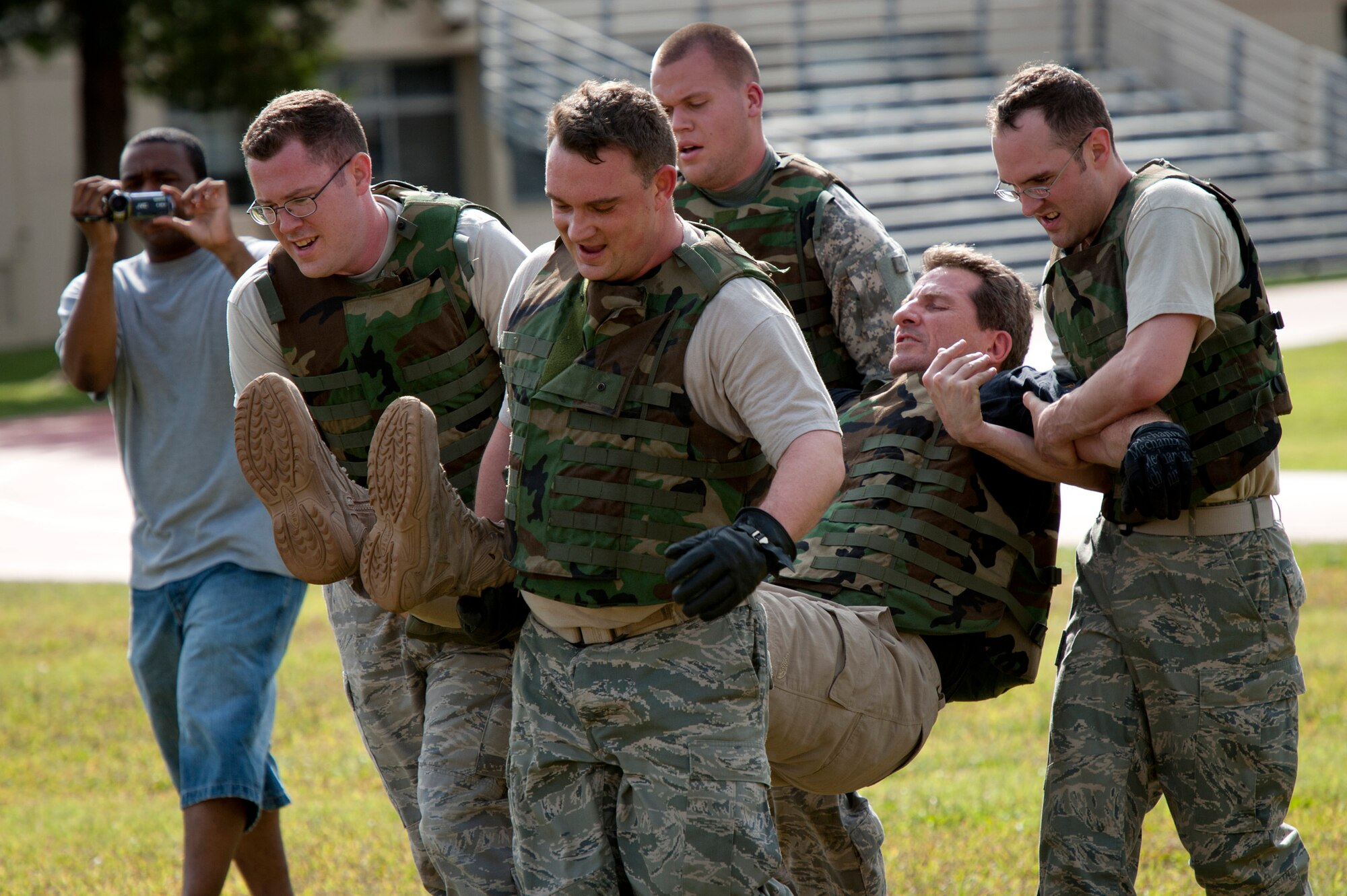 YOKOTA AIR BASE, Japan -- Airmen from the 730th Air Mobility Squadron carry one of their team mates as the fourth of 10 events making up the Combat Endurance Challenge at Yokota Air Base, Japan, Oct. 1, 2011. Each task simulated strenuous activities military members might face in combat, testing their endurance to see what team could complete all tasks in the least amount of time. (U.S. Air Force photo/Staff Sgt. Samuel Morse)