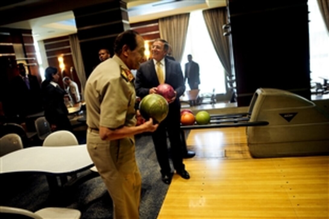 U.S. Defense Secretary Leon E. Panetta and  Field Marshal Hussein Tantawi enjoy an impromptu game of bowling while passing through a hotel's gallery in Cairo, Oct. 4, 2011.