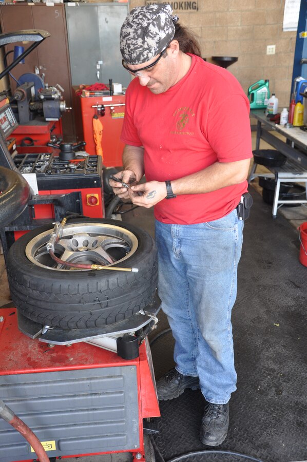 Barstow, Calif., native Robert Michaels assists customers with minor car repairs at the Marine Corps Logistics Base Barstow hobby shop. Michaels' father worked at Maintenance Center Barstow for 35 years.