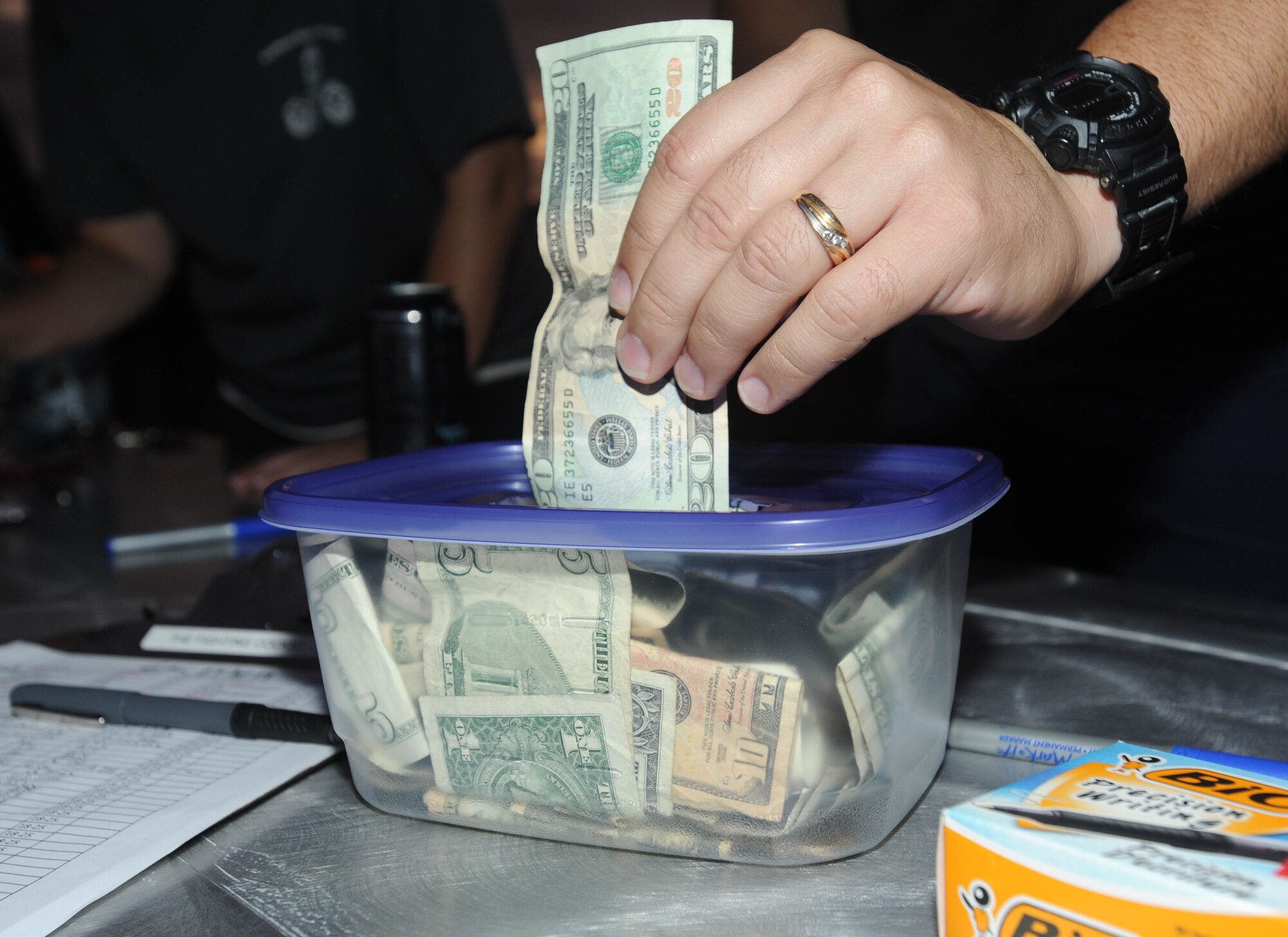 A Kadena first sergeant places a donation in a box during a challenge run fundraiser beginning at the Risner Fitness Center Sept. 30. The 6-, 10- and 20-kilometer runs were hosted by the Kadena first sergeants to support their non-profit program, Operation Warm Heart. The event raised $2,850 for the program, which provides support back to Team Kadena military and family members in particular situations.  (U.S. Air Force photo/Tech. Sgt. Amanda Savannah)