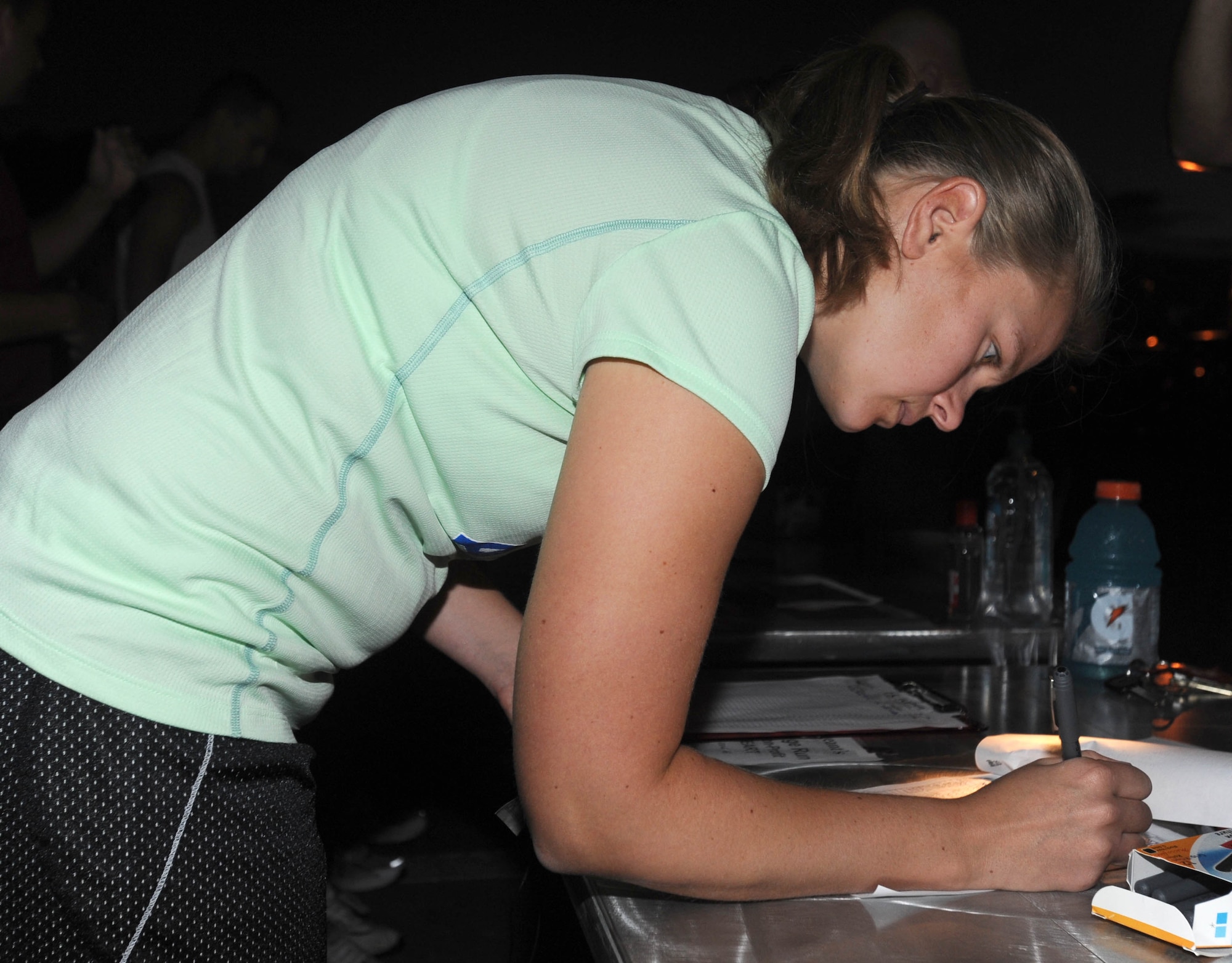 Capt. Leslie Woll, 961st Airborne Air Control Squadron assistant chief of tactics, registers to participate in a 20-kilometer challenge run fundraiser beginning at the Risner Fitness Center Sept. 30. The 6-, 10- and 20-kilometer runs were hosted by the Kadena first sergeants to support their non-profit program, Operation Warm Heart. More than 300 people registered to participate in the event. (U.S. Air Force photo/Tech. Sgt. Amanda Savannah)
