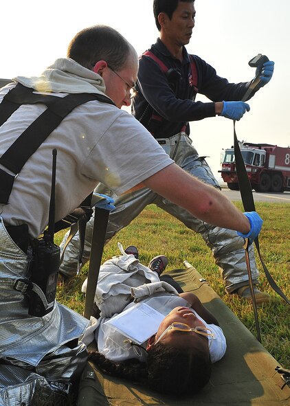 During an Emergency Management Exercise, Osan responders reacted to a simulated A-10 that collided with a CH-47, which then crashed into a static display during an airshow, here Oct. 5.  Fifth-graders from Osan Middle School helped with the exercise, giving it a 'real-feel'.  The students were moulaged up and spread across the flight-line serving as victims for first responders with wounds ranging from smoke inhalation to protruding insides.  This exercise gave Osan responders a chance to shine while responding to a very possible emergency scenario.  (U.S. Air Force Photo by/Staff Sgt. Daylena Gonzalez)