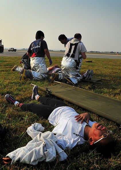 During an Emergency Management Exercise, Osan responders reacted to a simulated A-10 that collided with a CH-47, which then crashed into a static display during an airshow, here Oct. 5.  Fifth-graders from Osan Middle School helped with the exercise, giving it a 'real-feel'.  The students were moulaged up and spread across the flight-line serving as victims for first responders with wounds ranging from smoke inhalation to protruding insides.  This exercise gave Osan responders a chance to shine while responding to a very possible emergency scenario.  (U.S. Air Force Photo by/Staff Sgt. Daylena Gonzalez)