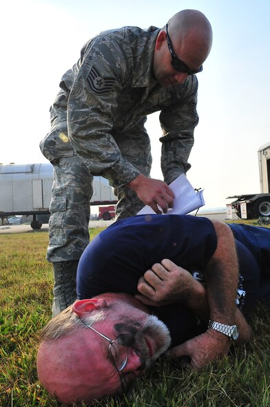 During an Emergency Management Exercise, Osan responders reacted to a simulated A-10 that collided with a CH-47, which then crashed into a static display during an airshow, here Oct. 5.  Fifth-graders from Osan Middle School helped with the exercise, giving it a 'real-feel'.  The students were moulaged up and spread across the flight-line serving as victims for first responders with wounds ranging from smoke inhalation to protruding insides.  This exercise gave Osan responders a chance to shine while responding to a very possible emergency scenario.  (U.S. Air Force Photo by/Staff Sgt. Daylena Gonzalez)