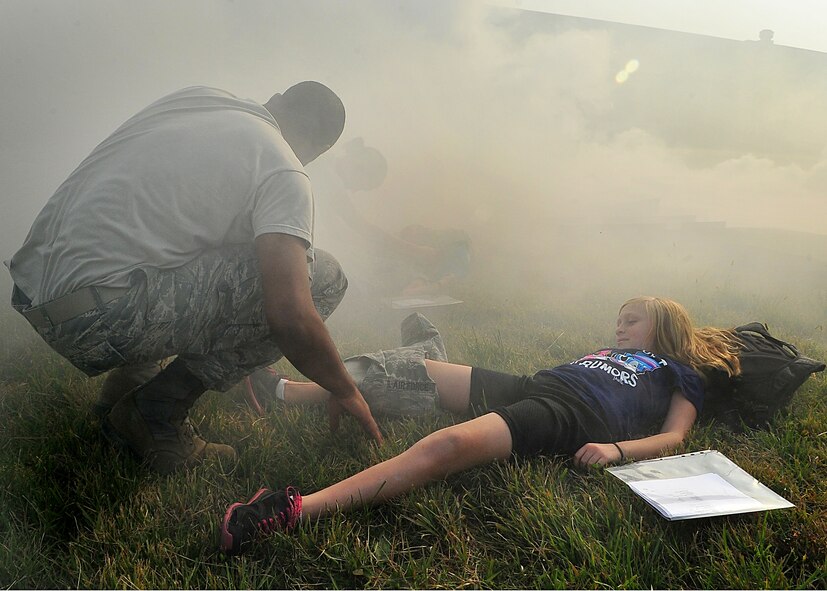 During an Emergency Management Exercise, Osan responders reacted to a simulated A-10 that collided with a CH-47, which then crashed into a static display during an airshow, here Oct. 5.  Fifth-graders from Osan Middle School helped with the exercise, giving it a 'real-feel'.  The students were moulaged up and spread across the flight-line serving as victims for first responders with wounds ranging from smoke inhalation to protruding insides.  This exercise gave Osan responders a chance to shine while responding to a very possible emergency scenario.  (U.S. Air Force Photo by/Staff Sgt. Daylena Gonzalez)