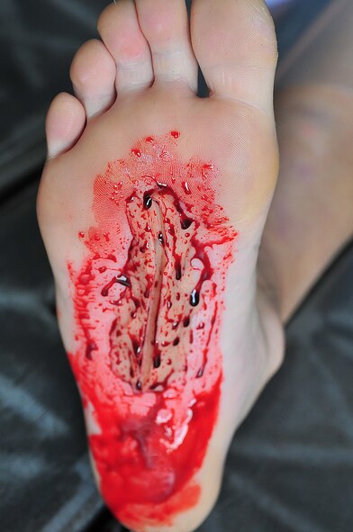 During an Emergency Management Exercise, Osan responders reacted to a simulated A-10 that collided with a CH-47, which then crashed into a static display during an airshow, here Oct. 5.  Fifth-graders from Osan Middle School helped with the exercise, giving it a 'real-feel'.  The students were moulaged up and spread across the flight-line serving as victims for first responders with wounds ranging from smoke inhalation to protruding insides.  This exercise gave Osan responders a chance to shine while responding to a very possible emergency scenario.  (U.S. Air Force Photo by/Staff Sgt. Daylena Gonzalez)