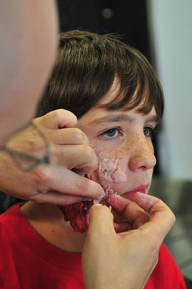 During an Emergency Management Exercise, Osan responders reacted to a simulated A-10 that collided with a CH-47, which then crashed into a static display during an airshow, here Oct. 5.  Fifth-graders from Osan Middle School helped with the exercise, giving it a 'real-feel'.  The students were moulaged up and spread across the flight-line serving as victims for first responders with wounds ranging from smoke inhalation to protruding insides.  This exercise gave Osan responders a chance to shine while responding to a very possible emergency scenario.  (U.S. Air Force Photo by/Staff Sgt. Daylena Gonzalez)