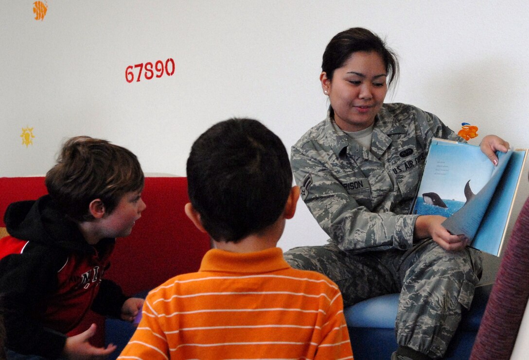 Airman 1st Class Klarence Dee Garrison reads to children in the Children’s Library on base. (Air Force photo by Kate Blais)

