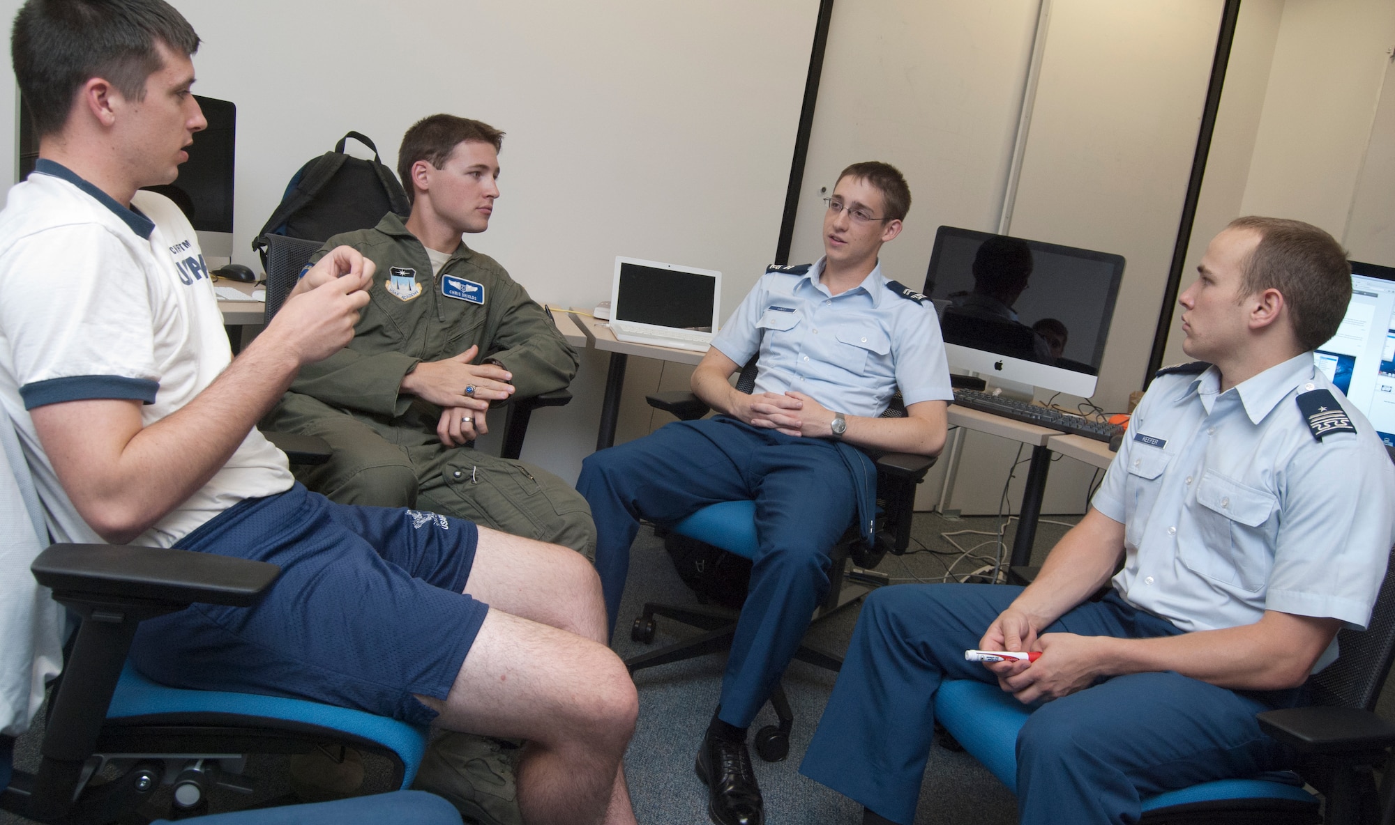 From left: Cadet 2nd Class Josh Christman, Cadet 1st Class Chris Shields, Cadet 2nd Class Nathan Hart and Cadet 1st Class Jordan Keefer discuss buffer overflow exploits during a cyber competition team meeting in the Air Force Academy's Cyberwarfare Lab Oct. 3, 2011. The team placed third out of 45 U.S. undergraduate teams in a competition hosted by the New York University Polytechnic Institute Sept. 23-25. Keefer is the team's cadet in charge. (U.S. Air Force photo/Don Branum)